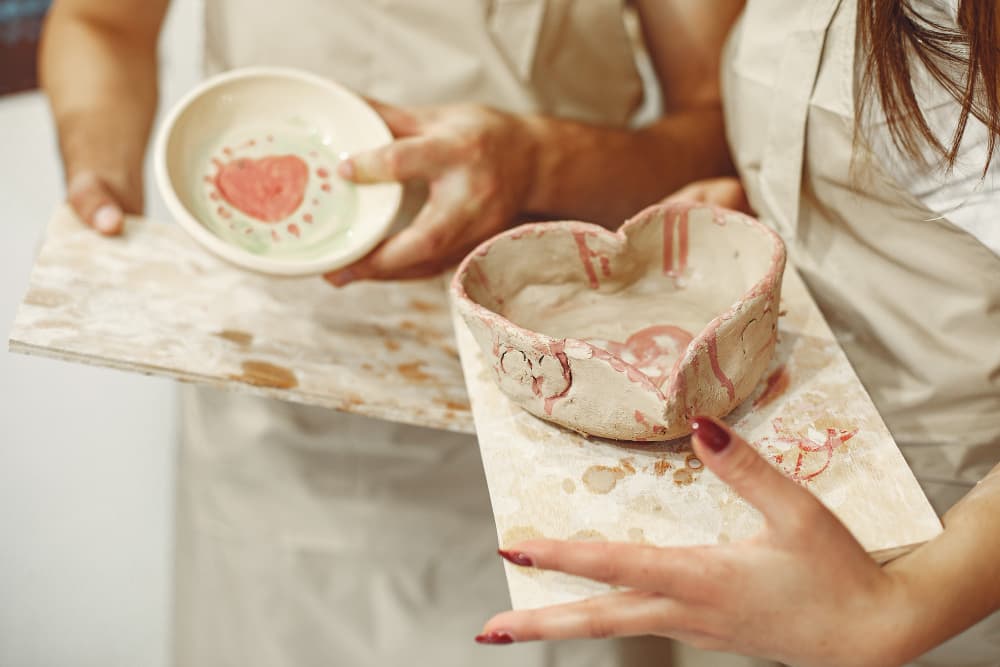 A latte beside a freshly painted ceramic piece